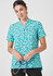 A teal and white patterned tunic top with a stand-up collar, featuring a logo on the chest.