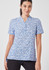 A women's tunic in blue and white with a stardust print, featuring a collar and short sleeves. It has a logo.