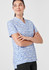 A women's tunic in a blue and white stardust print, featuring a collar and short sleeves. It has a branding logo.