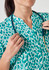 A turquoise tunic featuring a starlit print, with a collar and button detailing, paired with a stethoscope.