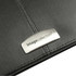 A black leather zippered compendium featuring a silver branding plate.