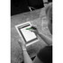 A stylus pen in green is being used on a tablet, with a person’s hand visible. The background features a textured surface.