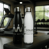 A drink bottle set featuring a black and a white stainless steel water bottle, each with a logo.