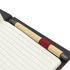A dark notebook with lined pages and a bamboo pen with a red grip placed inside.