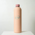 A drink bottle in a soft peach colour with a pink cap and a logo on the front.
