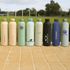 A drink bottle collection featuring pastel and dark colours with various logos displayed on each bottle.