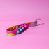 A colourful, pink and blue Popper Stress Reliever Key Chain with multiple popping buttons and a metal keyring.