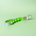 A green and white Popper Stress Reliever Key Chain featuring several poppable buttons and a metal keyring attachment.