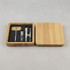 A bamboo manicure set featuring stainless steel tools, including scissors, a nail clipper, and a cuticle pusher, in a wooden box.