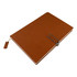 A brown notebook with a textured cover, featuring a metal clip and bookmark. It has branding on the front.