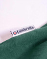 Lambretta Mens Casual Classic Twin Tipped MOD SKA Polo Shirt, close-up of the shirt's label and fabric showing the brand tag stitched into the green textured fabric.
