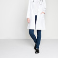 Birkenstock Tokio Super Grip Mens SRA Work Kitchen Garden Shoes - Regular Width, black slip-resistant work shoes worn by a person in a white lab coat and jeans with a stethoscope, suitable for work environments.