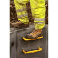 Amblers Safety Amblers FS998 Mens Safety Side Zip Composite Toe Midsole S3 Work Boots, construction worker's safety boots covered in mud on a construction site.