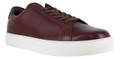 Thomas Crick Evers Mens Casual Lace Up Smart Leather Cupsole Trainers, close-up view of brown leather sneakers with white rubber sole and brown shoelaces.
