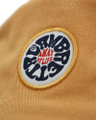 Lambretta Mens Bucket Classic Logo Festival Summer Hat, close-up of embroidered logo patch on tan fabric.