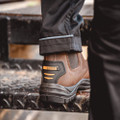 WorkTough Mens Dealer Work Safety Steel Toe Midsole Ankle Boots, close-up of a brown safety work boot with steel toe and midsole protection, worn by a person standing on a metal surface.