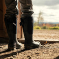 Muck Boots MUCK Chore XF Adjustable Womens Classic Stable Farm Wellington Wellies, black waterproof rubber boots worn outdoors on a farm.