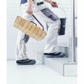 Safety2Shoes Re-useable Shoe Covers Overshoe Carpet Floor Boot Protector, person wearing slip-on shoe covers while walking on tiled indoor stairs with construction or renovation materials.