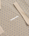 Lambretta Mens Geometric Target Retro Mod Ska Casual Polo Shirt, close-up of the shirt's detailed geometric pattern with circular designs in beige and black, and the Lambretta logo.