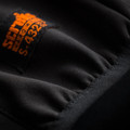 Scruffs Mens Softshell Zip Up Work Warm Hooded Jacket Coat, close-up of the black fabric and orange logo tag on the jacket.