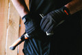 Scruffs Trade Work Mens Padded Palm Gloves, black work gloves with padded palms and grip enhancement, worn for durability and protection during manual tasks.