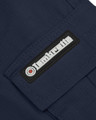 Lambretta Mens Utility Cargo Casual Summer Shorts, close-up image of the Lambretta logo tag on navy blue shorts.