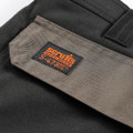 Scruffs Worker Plus Holster Mens Multi Pocket Cargo Shorts, close-up of the grey label on the black shorts showing the brand and product details.