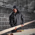 Scruffs Tech Mens Zip Up Work Warm Hooded Jacket Coat, a man wearing a waterproof hooded jacket working outdoors in rainy weather.