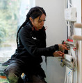 Scruffs Trade Hoodie Womens Pull Over Sweat Shirt Jumper, woman working on electrical wiring in a workshop.