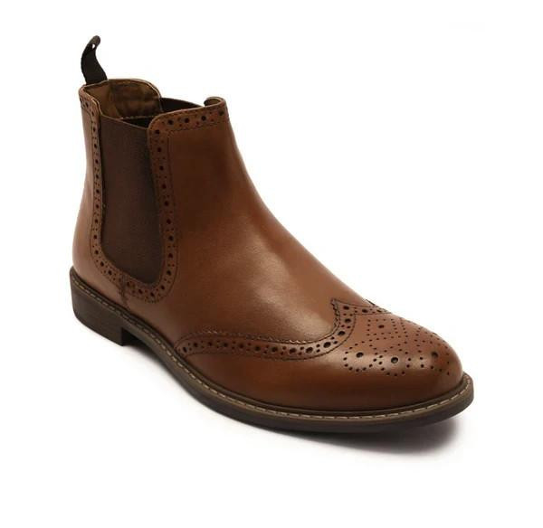 Thomas Crick Downtown Mens Classic Leather Wingtip Brogue Ankle Boots, a men's ankle boot made of polished brown leather with brogue detailing and a slip-on style with elastic side panels.