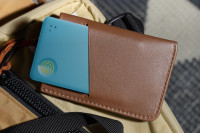 A Life360 Tile Slim - Aqua Lemon inside of a cardholder.