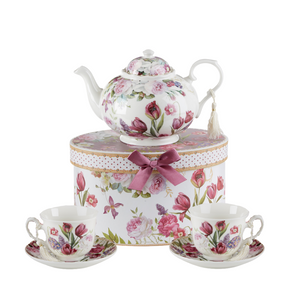 Tulip Tea Set, will brighten anyone's day with this beautiful tea set in its own matching print gift box with matching satin ribbon. A decorative tassel on the handle adds a lovely finishing touch. Gifting Idea: birthday gift, bridal shower, get well, treat yourself or someone you love. Includes: 9.5 x 5.6" Porcelain teapot, hold 4 cups (32 oz) 2 cup/saucer Soft white background with a purple tulip floral print Dishwasher safe Tea choices available to add to your order in the loose-leaf shop Teas and Teaware are shipped together, Cornucopia Teas come in resealable pouches with decorative tea labels, and includes a brewing guide. If purchasing as a gift your personal message is included on the pamphlet. Tulip Tea Set, will brighten anyone's day with this beautiful tea set in its own matching print gift box with matching satin ribbon. A decorative tassel on the handle adds a lovely finishing touch. Gifting Idea: birthday gift, bridal shower, get well, treat yourself or someone you love. Includes: 9.5 x 5.6" Porcelain teapot, hold 4 cups (32 oz) 2 cup/saucer Soft white background with a purple tulip floral print Dishwasher safe Tea choices available to add to your order in the loose-leaf shop Teas and Teaware are shipped together, Cornucopia Teas come in resealable pouches with decorative tea labels, and includes a brewing guide. If purchasing as a gift your personal message is included on the pamphlet.