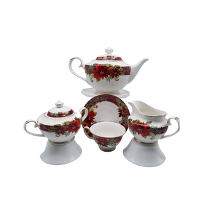 Red Poinsettia 11 pc - Tea Set: a beautiful Christmas poinsettia print tea set made of porcelain. 1 Teapot, 1 Set of Sugar & Creamer, and 4 Sets of Cup & Saucer. Gold Trimmed. Add one of Cornucopia's Loose Leaf Christmas Tea blends to finnish off this special holiday gift. Includes: 1 Teapot, 1 Set of Sugar & Creamer, and 4 Sets of Cup & Saucer. Gold Trimmed. Made of Porcelain. Dishwasher safe Choose a Christmas Tea by the Cornucopia Shop These specialty loose leaf teas are Christmas holiday blends that are seasonal favorties in herbals and black tea base with christmas spice blends, marshmallow, pear, organge and chocolate. Robust flavors, chuncky fruites and chocolate pieces to endulge and enjoy this holiday season. Teas and Teaware are shipped together, Cornucopia Teas come in resealable pouches with decorative tea labels, and includes a recipe and brewing guide. If purchasing as a gift your personal message is included on the pamphlet. Enclosed Gift Card Sample - Standard Cover and coupon with your personalized gift message. 200 characters max. Red Poinsettia 11 pc - Tea Set: a beautiful Christmas poinsettia print tea set made of porcelain. 1 Teapot, 1 Set of Sugar & Creamer, and 4 Sets of Cup & Saucer. Gold Trimmed. Add one of Cornucopia's Loose Leaf Christmas Tea blends to finnish off this special holiday gift. Includes: 1 Teapot, 1 Set of Sugar & Creamer, and 4 Sets of Cup & Saucer. Gold Trimmed. Made of Porcelain. Dishwasher safe Choose a Christmas Tea by the Cornucopia Shop These specialty loose leaf teas are Christmas holiday blends that are seasonal favorties in herbals and black tea base with christmas spice blends, marshmallow, pear, organge and chocolate. Robust flavors, chuncky fruites and chocolate pieces to endulge and enjoy this holiday season. Teas and Teaware are shipped together, Cornucopia Teas come in resealable pouches with decorative tea labels, and includes a recipe and brewing guide. If purchasing as a gift your personal message is included on the pamphlet. Enclosed Gift Card Sample - Standard Cover and coupon with your personalized gift message. 200 characters max.