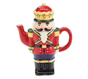 Hand wash only/FDA approved.
Standing nutcracker shaped ceramic teapot. The nutcracker has a red jacket, blue pants, and black boots with yellow/gold accents. The teapots have a red handle and spout. 8.25"H X 6.75"W X 3"D / 1.75"Opening
14 oz 
Hand wash only/FDA approved.
Nutcracker head shaped mug with raised elements. The nutcracker is red, gold, white, and green with a solid red handle. 4"H X 5.75"W X 4"D / 3"Opening
18 oz Hand wash only/FDA approved.
Standing nutcracker shaped ceramic teapot. The nutcracker has a red jacket, blue pants, and black boots with yellow/gold accents. The teapots have a red handle and spout. 8.25"H X 6.75"W X 3"D / 1.75"Opening
14 oz 
Hand wash only/FDA approved.
Nutcracker head shaped mug with raised elements. The nutcracker is red, gold, white, and green with a solid red handle. 4"H X 5.75"W X 4"D / 3"Opening
18 oz