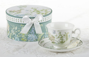 Blue Hydrangea Cup/Saucer in gift box, will brighten anyone's day in its own matching print gift box with matching satin ribbon. A decorative tassel on the handle adds a lovely finishing touch. Gifting Idea: birthday gift, bridal shower, get well, treat yourself or someone you love.   Includes:  3.5" Cup/Saucer in gift box Soft white background with a Blue Hydrangea and pastel floral print Dishwasher safe  Other Items Available:  Matching Teapot available D8150-4  Tea choices available to add to your order in the loose-leaf shop   Teas and Teaware are shipped together, Cornucopia Teas come in resealable pouches with decorative tea labels, and includes a recipe and brewing guide. If purchasing as a gift your personal message is included on the pamphlet.
