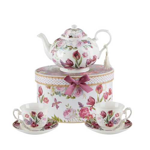 Tulip Tea Set, will brighten anyone's day with this beautiful tea set in its own matching print gift box with matching satin ribbon. A decorative tassel on the handle adds a lovely finishing touch. Gifting Idea: birthday gift, bridal shower, get well, treat yourself or someone you love.   Includes:  9.5 x 5.6" Porcelain teapot, hold 4 cups (32 oz)  2 cup/saucer Soft white background with a purple tulip floral print Dishwasher safe  Tea choices available to add to your order in the loose-leaf shop   Teas and Teaware are shipped together, Cornucopia Teas come in resealable pouches with decorative tea labels, and includes a brewing guide. If purchasing as a gift your personal message is included on the pamphlet.