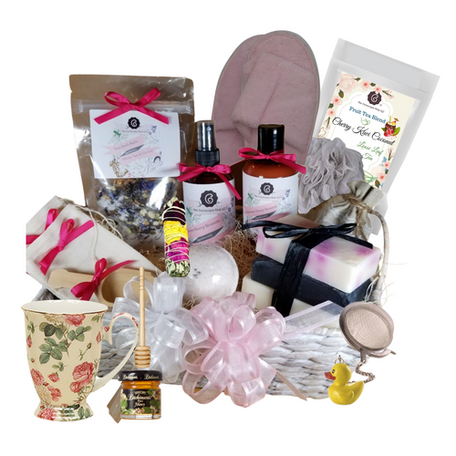 White Tea & Orchid – Luxury Spa Gift Basket by The Cornucopia Shop LLC: Our Bath Soaks are made of the highest quality ingredients of botanicals, Teas, Essential Oils, Dead Sea Bath Salts, Epsom Bath Salts, & Pink Himalayan Salts. Aromatherapy to lift and rejuvenate the mind.  Our line includes Hand Crafted Cold Process Soaps, Body Lotions and Perfume Body Sprays, and Luxury Bath Bombs to sooth, soften and re-fresh. Dried Botanical Lingerie Sachet to scent a drawer.    Includes:   1- Spa basket, whitewashed natural fiber basket with handles, 1- Porcelain Chintz pattern coffee/tea footed mug, 1 oz Cornucopia Cherry Kewi Coconut Fruit Tea,  1- Mini Honey, 1- Wood Honey Spool, 1- Stainless steel tea ball with Charm 1 1/2 ", 1 - Smudge Stick, burn to cleans an area of your home for spiritual renewal.  1 - Ladies open toe Spa Slipper, Terry Cloth (fits most), 1- 4 oz White Tea & Orchid Bath Salts all-natural no dyes,  1- 8 oz Japanese Cherry Blossom Body Lotion 1- 8 oz Japanese Cherry Blossom Body Spray 1-.05 oz Super Lavender Drawer Sachet 2- Linen Bath Tea Bags (reusable) hand wash 1- Wooden Bath Salt Scoop  1- Loofah & Terry Cloth reversible Wash Pad with Wrist Band 5 oz 2 1/2 “, Vanilla Caramel with jewel top Bath Bomb 3 Cold Process Bar Soaps, Japanese Tea Blossom, White Tea & Ginger Black Soap with activated charcoal  Gift comes shrink wrapped in reusable whitewashed natural fiber basket with handles, natural fiber fill, decorative gift bow, and enclosure gift card.  Key Ingredients: Bath Salt: Organic White Tea & Orchid loose leaf tea, Epsom Salts, White Tea and Orchid Essentail Oil. Organic Jasmine flowers, Blue Corn Flowers. Body lotion:Water, Blend of (Coconut Oil, Hempseed Oil, Sunflower Oil, Vitamin E, Mineral Oil), Propylene Glycol, Stearic Acid, Cetyl Alcohol, Phenoxyethanol, Ethylhexylglycerin, Glyceryl Stearate, Petrolatum, TEA 99%, Proprietary Fragrance and Essential Oil Blend, Dimethicone, Carbopol, Disodium EDTA, Allantoin, Aloe Vera Gel. Perfume Body Spray:Water, Ploysorbate 20, Fragrance,,DMDM Hydntoin, Disodium EDTA Cold Process Soaps: Olive Oil, Soybean Oil, Coconut Oil, Corn Oil. Sunflower Oil, Organic Shea Butter, Water. Sodium Hydroxide (Lye), Fragrance INCI: Olea Europaea (Olive) Oil, Glycine Soja (Soybean) Oil, Cocos Nucifera (Coconut) Oil, Zea Mays (Corn) Oil, Helianthus Annuus (Sunflower) Seed Oil, Butyrospermum Parkii (Shea Butter), Aqua, Sodium Hydroxide, Fragrance. May contain charcoal, FD&C color. Please note, that due to the handmade nature of this soap, color shades and swirl styles may slightly vary. Each loaf and bar are unique!
