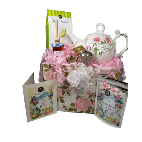 Humming Bird Teapot with Tea Gift: This lovely Tea and Teapot gift set with mini honey, honey spool, and teapot teaball sends happy greetings just in time for tea!   16 oz. by Kent pottery Teapot, White with Humming Bird and Rose floral print in shades of pink with gold trim.  Dishwasher and microwave safe. 1 oz of Cornucopia Shop's Organic Loose Leaf 7T6410 White Peony (Loose Leaf) is a delicate, crisp white tea known for its neutral, nut-like character. Ingredients: Organic white tea. Taste: Spring Fruit & Flowers (Loose Leaf) offers a light, floral flavor profile with a subtle berry finish. Mini Honey 1 oz Honey Spool, Wooden  Teaball by Cha Cult, with teapot charm chain, stainless steel  2" ball  1-2.5 oz. - J&M Tea Cookies -(Raspberry, Lime, or Lemon) depending on avialability.     Gift comes in a gift basket tray shrink wrapped with hand made bow.  Enclosure card with 10% off coupon on purchase of tea, and your personal gift message.