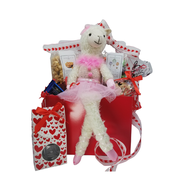 Valentine Lama Plush Gift Basket: This sweet dangling legged White Lama with a Pink Tutu happy to greet your Valentine with gourmet treats of specialty popcorn, sugar cookies, Chocolate Fudge Bites, and Ghirardelli single squares all tucked inside a red gift basket box, the pretties white and red valentine hearts ribbon and a free Valentine's Day greeting card.  Note Plush Lama is a decorative piece for tweens up.   Includes:  Plush 19" Sitting Balle Lama in a pink tutu 2 oz Valentine bag Vanilla Crunch Cookie Bites, 3 pc Ghirardelli assorted chocolates, milk, dark, caramel, 2 oz Valentine Box of Chocolate Fudge Bites,  6 oz Gourmet Popcorn by Jocelyn Co. in two most popular flavors: Caramel Vanilla, Fruity Tootie.   Gift is wrapped in cellophane and tied with handmade bow.  A Valentine enclosure card with your personal gift message
