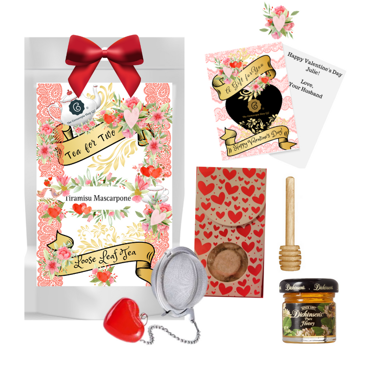 Valentine Tea Gift Set - Tea For Two: Love is in the air and so are sweet tea gifts for that someone special in your life, a very good friend, or family member like Mom or your favorite sister!   Includes all they need to make the perfect cup of love this Valentine season.  

Gift Includes: 

1 oz. approx yields 12 cups.  Tiramisu/Mascarpone Rooibos (Loose Leaf): Taste: The light Irish coffee taste, complemented by a hint of sweet caramel pieces, is refined by mascarpone. Coffee lovers will be delighted and forget it's tea.  Ingredients:Rooibos tea, chocolate chips (sugar, ground cocoa beans with cocoa butter, powdered cocoa, emulsifying agent: soy lecithin), brittle pieces (sugar, hazelnuts, invert sugar), cream-caramel pieces (sweetened condensed skimmed milk, sugar, glucose, molasses, butter fat, wetting agent: sorbitol, emulsifying agent: mono- and diglyceride of edible fatty acids), flavoring, freeze-dried yoghurt granules (skimmed milk yogurt, sugar, maltodextrin, modified starch, acidifying agent: citric acid), roasted coffee beans, Roman camomile. Cornucopia Teas are of the highest quality and sourced from plantations around the world.  Our teas come in resealable pouches with decorative tea labels. 
1 Mini 1 oz. Dickinson's Honey,
1 Honey spool,
1 Heart Tea ball, Stainless Steal, made in Germany by Cha Cult,
1 Valentine box 2 oz. Gourmet Sugar Love Cookie bites. 

Gift Wrapping: This gift is in a cello bag with red ribbon.  A complementary Valentine's Day card with your personal message, with a 10% off coupon of first purchase of tea, tucked inside the shipping box.