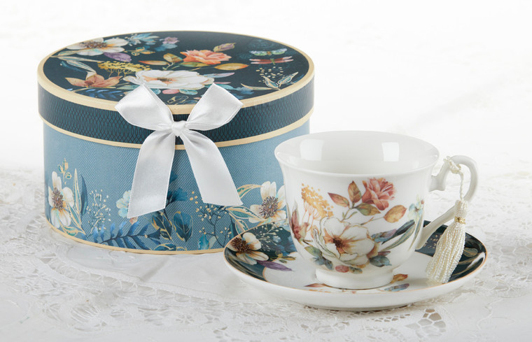 English Camellia  Cup/Suacer, will brighten anyone's day with this beautiful tea set gift in its own navy and teal flower print gift box with matching satin ribbon. A decorative tassel on the handle adds a lovely finishing touch. Gifting Idea: birthday gift, bridal shower, get well, treat yourself or someone you love.   Includes:  3.5" Cup/Saucer in gift box Soft white background with navy and teal floral print Dishwasher safe  Other Items Available:  Matching Teapot available D8150-4  Tea choices available to add to your order in the loose-leaf shop   Teas and Teaware are shipped together, Cornucopia Teas come in resealable pouches with decorative tea labels, and includes a recipe and brewing guide. If purchasing as a gift your personal message is included on the pamphlet.