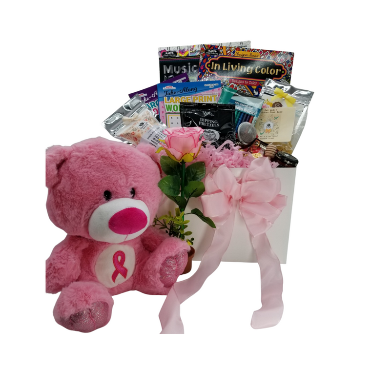 Healing Wishes -Pink Ribbon Bear Care Basket: This healing wish care basket is filled with thoughtful items that provide, a message that it’s okay to take it easy and heal.  It’s filled with healthy treats, a little fun, and lots of loving thoughts.  A pink ribbon plush bear, so soft and cuddly.  Healthy tea, (great for chemo patients) mini honey, and tea ball to help keep them hydrated, chicken soup base mix. And when they’re feeling better, adult coloring books and colored pencils and a flower potted pen just to add a little silly to work on crossword and word find puzzle books, and a little sweet option with Raspberry or shortbread cookies to have with their tea.   Plush Pink Ribbon Care Bear for those who are facing breast cancer treatment, Potted Rose Pen, 2 Adult Coloring Books, Colored Pencil Set, Crossword and Word Find Puzzle Books, 1 oz 12 cups Cornucopia’s Detox Tea (Loose Leaf) Ingredients: Organic lemongrass leaf, organic echinacea purpurea herb, organic licorice root, organic dandelion root, organic peppermint leaf, organic Tulsi leaf and organic ginger root. 1 1/2" Tea Ball, stainless steel, Dickinson's Mini Honey 1 oz, Honey Spool wooden, Chicken Noodle Soup Base, by Rabbit Creek for the Cornucopia Shop, East Shore Dipping Pretzel, 4 oz Walker's Fingers Shortbread Cookie -2 pack, 5 oz J & M Raspberry Tea Cookies.  Gift comes wrapped in cellophane with hand tied bow, a complimentary enclosure card with your personal get well message