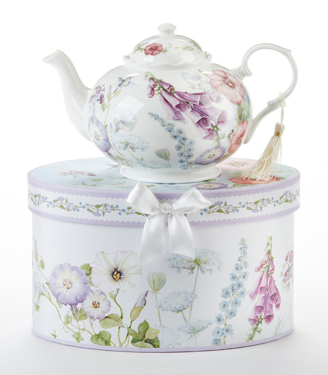 Bell Isle Teapot in Gift Box Teapot 32 oz in gift box, will brighten anyone's day with this beautiful teapot gift in its own matching print gift box with matching satin ribbon. A decorative tassel on the handle adds a lovely finishing touch. Gifting Idea: birthday gift, bridal shower, get well, treat yourself or someone you love.   Includes:  9.5 x 5.6" Porcelain teapot, 4 cups (32 oz) Soft white background with purple, blues, pink and white floral print Dishwasher safe