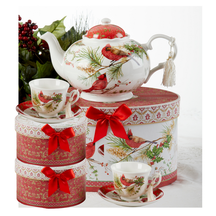 Cardinal Christmas Tea set-service for 2, a beautiful Christmas tea set in its own matching print gift box with coordinating satin ribbon. A decorative tassel on the handle adds a lovely finishing touch. To be enjoyed throughout the holiday season, makes a lovely gift for that special tea drinker on your gift list!    Add one of Cornucopia's Loose Leaf Christmas Tea blends to finnish off this special holiday gift.   Includes:  9.5 x 5.6" teapot 2 cup and saucer set, in matching keepsake gift box,   Soft white with a Christmas floral print background with Christmas Cardinals in matching keepsake gift box,  Dishwasher safe   Enclosed Gift Card Sample - Standard Cover and coupon with your personalized gift message. 200 characters max.