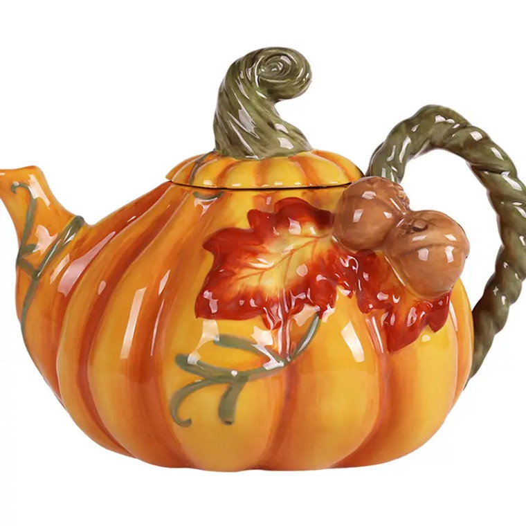 Experience the charm of Blue Sky Clayworks with our Pumpkin Teapot. This teapot, designed by our world-renowned artist Heather Goldmine, showcases our uniqueness and craftsmanship that sets us apart. Perfect for any home living setting, it adds a seasonal touch to your kitchen tabletop while enhancing your tea experience. Enjoy your favorite brew in this handcrafted and hand-painted ceramic teapot. A delightful addition to your coffee and tea ware collection. • Made in China • Weight: 2 lb (0.91 kg) • Dimensions: 9 x 7 x 7 in (22.9 x 17.8 x 17.8 cm)