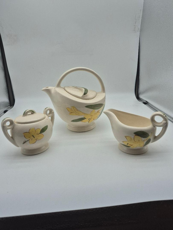 Red Wing Pottery Yellow Flower Tea Set Comes with A Teapot A Creamer, and Sugar with the Yellow Flower design.

Red Wing Pottery is a significant name in American ceramics, representing over 150 years of stoneware, art pottery, and dinnerware production centered in Red Wing, Minnesota. Production began in 1861 when German immigrant John Paul discovered suitable clay in Goodhue County. Red Wing Stoneware Company (est. 1877): The first major organized pottery in the area.
