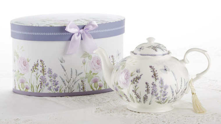 Lavender Fields Teapot 4 cups in gift box, will brighten anyone's day with this beautiful teapot gift in its own lavender flower print gift box with matching satin ribbon. A decorative tassel on the handle adds a lovely finishing touch. Gifting Idea: birthday gift, bridal shower, get well, treat yourself or someone you love.   Includes:  9.5 x 5.6" Porcelain teapot Soft white background with lavender floral print Dishwasher safe   Other Items Available:  Matching cup and saucer available D8101-7   Tea choices available to add to your order in the loose-leaf shop   Teas and Teaware are shipped together, Cornucopia Teas come in resealable pouches with decorative tea labels, and includes a recipe and brewing guide. If purchasing as a gift your personal message is included on the pamphlet.