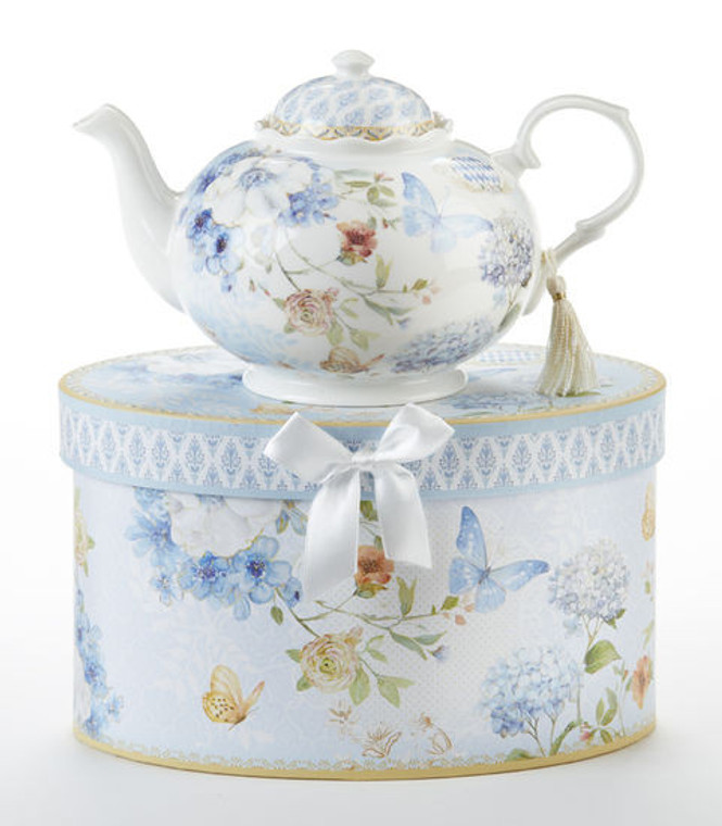 Blue Butterfly Teapot 32 oz in gift box, will brighten anyone's day with this beautiful teapot gift in its own matching print gift box with matching satin ribbon. A decorative tassel on the handle adds a lovely finishing touch. Gifting Idea: birthday gift, bridal shower, get well, treat yourself or someone you love.   Includes:  9.5 x 5.6" teapot Soft white background with a Blue Butterfly and pastel floral print Dishwasher safe  Other Items Available:  Matching cup and saucer available D8151-4  Tea choices available to add to your order in the loose-leaf shop   Teas and Teaware are shipped together, Cornucopia Teas come in resealable pouches with decorative tea labels, and includes a recipe and brewing guide. If purchasing as a gift your personal message is included on the pamphlet.