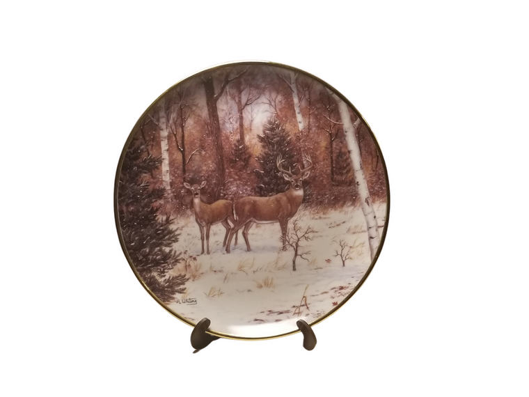 Collection Plate - In Winter Woods   A pair of Deer in a winter wood setting with snowfall.   Artist: Judi Whiting, Signed limited addition  Certificate of Authenticity by the International Wildlife Coalition, Designated an Heirloom by the Franklin Mint. Porcelain with 24K gold trim on rim and numbered