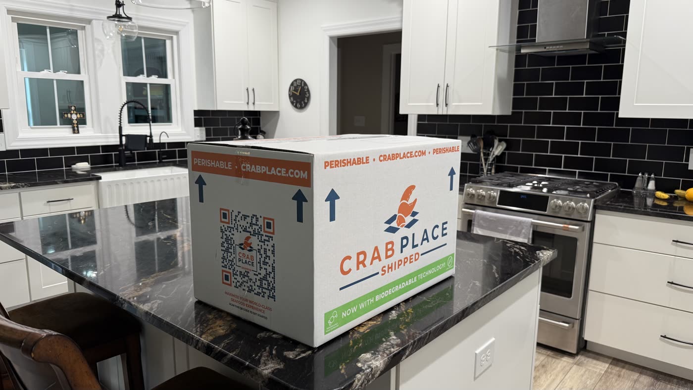 Crab Place shipping box on a kitchen counter with the QR code and logo facing forward